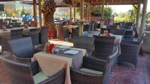 an outdoor dining area with tables and chairs at Sidari Waterpark in Sidari