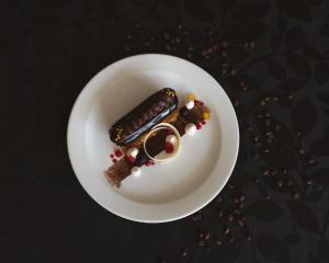 a white plate with a piece of food on it at Signature Club Resort in Devanahalli-Bangalore