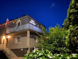 a building with a sign on it at night at Villa Arkodes in Gdańsk