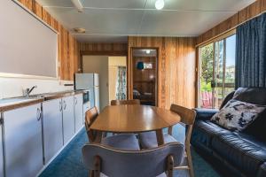 a kitchen and living room with a table and a couch at BIG4 Stanley Holiday Park in Stanley