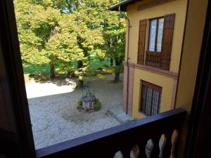 a view of a garden from a balcony of a building at Elegant Holiday Home in Faenza with Garden and Pool in Faenza