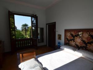 a bedroom with a large bed and a large window at Elegant Holiday Home in Faenza with Garden and Pool in Faenza