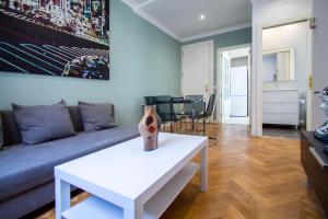 a living room with a couch and a table at Apartamentos Dali Madrid in Madrid