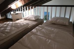 dos camas sentadas una al lado de la otra en un dormitorio en Apartamento PinosPenthouse pie de pistas La Molina, en La Molina