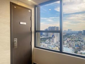 an elevator in an office with a view of a city at SOHO 23 Floor Stunning City View Apartment Near Bui Vien Ben Thanh in Ho Chi Minh City