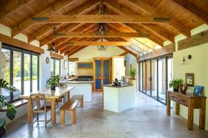 a kitchen with wooden ceilings and a table and chairs at The River House Wanaka in Wanaka