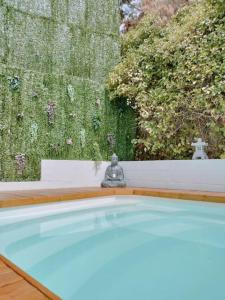 a swimming pool in a backyard with a garden at Casa Rural Las Adelfas in Cómpeta