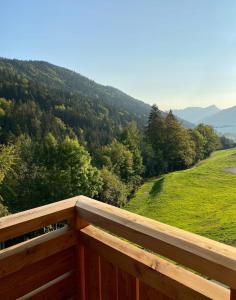 a wooden balcony with a view of a mountain at Les Lucioles - Charming flat in the mountains in Saint-Jean-de-Sixt