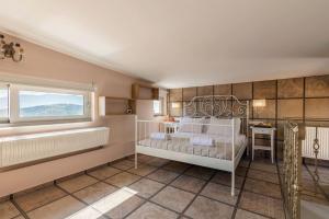 a bedroom with a white bed and a window at Serenity house near Heraklion in Stavrákia
