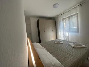 1 dormitorio con 1 cama con 2 toallas en appartamento Alpi Orobie, en Morbegno