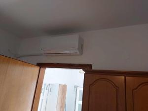 a room with a air conditioner on the ceiling at Studio με όλες τις ανέσεις in Vétrina