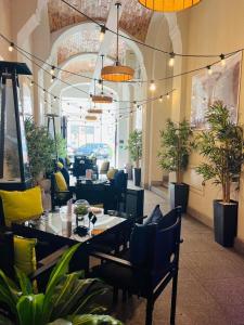 un ristorante con tavoli, sedie e piante in vaso di No1 Bed&Breakfast Restauracja ŚNIADANIE I PARKING W CENIE! a Leszno