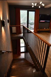 a staircase in a house with a large window at Kazbegi 4U in Stepantsminda