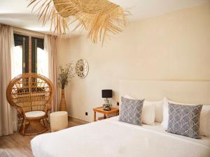 a bedroom with a bed with blue and white pillows at Dar Jasmine in Chefchaouene