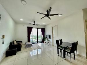 a living room with a ceiling fan and a table at Entire Condominium @ Woodsburry Butterworth Penang in Butterworth