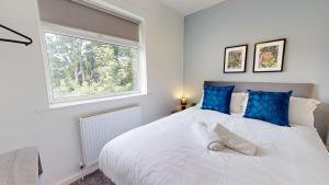 a bedroom with a large white bed and a window at Daventry House Stockton by Horizon Stays in Stockton-on-Tees