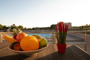 a bowl of fruit and vegetables sitting on a table at Apanemo Kourouta Luxury Villas in Kourouta