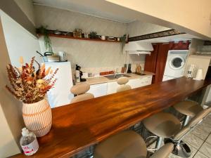 a kitchen with a counter with a vase of flowers on it at Os-thel, Chambres à louer in Tautavel