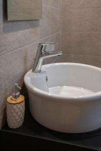 a bathroom sink with a faucet on a counter at Apanemo Kourouta Luxury Villas in Kourouta