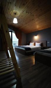 a hotel room with two beds and a staircase at Kazbegi 4U in Stepantsminda