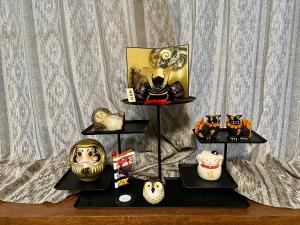 a display of masks and other items on a shelf at 已暂停 in Kyoto