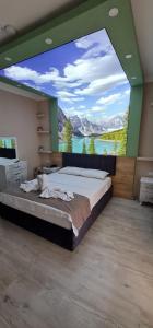 a large bedroom with a large window with a large bed at Seydikemer Yıldız hotel 