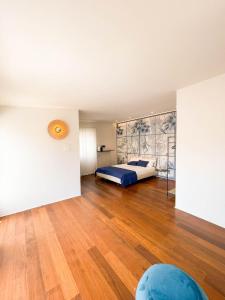 a bedroom with a bed and a wooden floor at Terrazzini Cibele in Andria