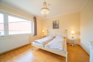 a bedroom with a bed and a large window at Maisonette Parforce in Gorleben