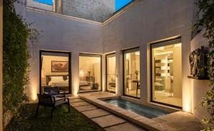a house with a swimming pool and a bedroom at La Fiermontina Luxury Home Hotel in Lecce