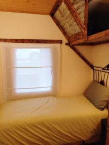 Habitación pequeña con cama y ventana en Precioso apartamento en la Cerdanya (6 personas)., en La Molina