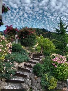 a set of stone stairs in a garden with flowers at Appartement Haus Tanja in Haus im Ennstal