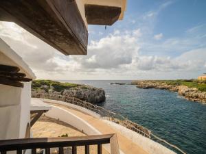 a view of the ocean from the balcony of a house at Authentic apartment in Binibeca Vell with private terrace in Binibeca