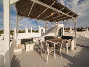 a wooden table and chairs on a patio at Authentic apartment in Binibeca Vell with private terrace in Binibeca