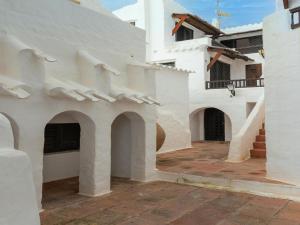 a white building with arches and a courtyard at Authentic apartment in Binibeca Vell with private terrace in Binibeca +84 photos
