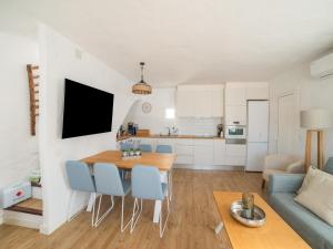 a kitchen and living room with a table and chairs at Authentic apartment in Binibeca Vell with private terrace in Binibeca