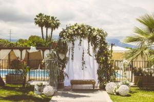 a wedding arch with flowers and a pool at Hotel Tossal d'Altea in Altea