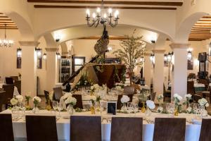 a dining room with tables and chairs and a chandelier at Hotel Tossal d'Altea in Altea