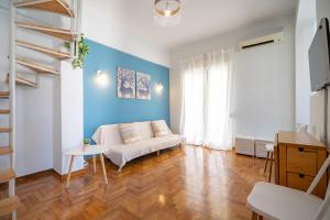 a living room with a white couch and a blue wall at Piraeus 2 bedrooms 4 persons apartmnet by MPS in Piraeus