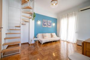 a living room with a white couch and a blue wall at Piraeus 2 bedrooms 4 persons apartmnet by MPS in Piraeus