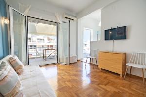 a living room with a bed and a sliding glass door at Piraeus 2 bedrooms 4 persons apartmnet by MPS in Piraeus