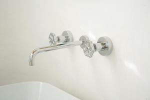 a shower handle with diamonds on a white wall at Dimora Storica Villa Pasquale Capri in Capri