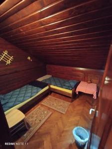 a small room with two beds in a cabin at Planinski dom Vrhe in Trbovlje