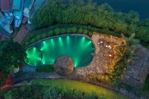 an overhead view of a swimming pool at night at Mai Chau Hideaway Lake Resort in Mai Chau