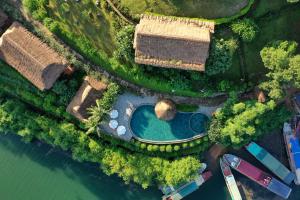 an overhead view of a swimming pool next to the water at Mai Chau Hideaway Lake Resort in Mai Châu