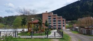 a building with a gazebo in front of a building at New apartments in borjomi in Borjomi