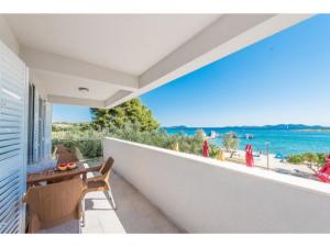 a balcony of a house with a view of the ocean at Modern apartment right on the Janice beach in Pakostane centre 50 m away in Pakoštane