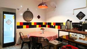 a table in a kitchen with a table and chairs at Way Hostel Madrid in Madrid