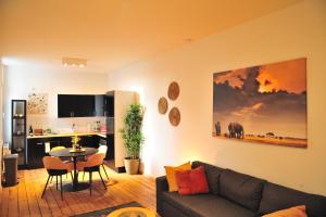 a living room with a couch and a table at The Oasis apartment, 2 bedrooms antwerp South in Antwerp