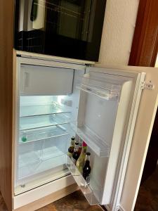 an open refrigerator with bottles of beer in it at Kleinod Dittmannsdorf in Dittmannsdorf