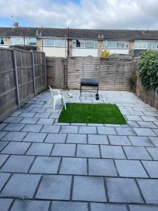 a patio with a bench and a chair in a yard at Tilbury Docks Rooms for Short letting in Tilbury